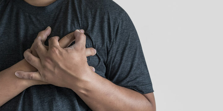 Person holding hands over chest near heart