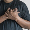 Person holding hands over chest near heart