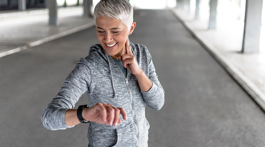 Person checking their heart rate while exercising outdoors