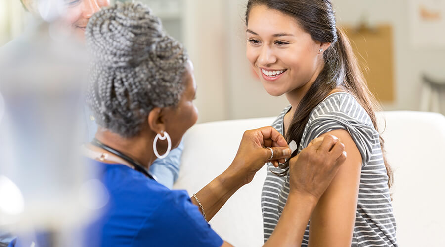 Person receiving a vaccine shot from a doctor Person receiving a vaccine shot from a doctor