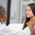 Doctor examining a patient's throat
