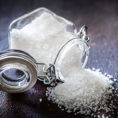Container of salt spilled out onto the table