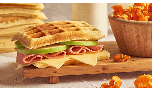 Sandwich with waffles, turkey, cheese and apple slices
