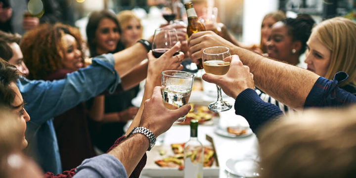 Group of people toasting with glasses at gathering