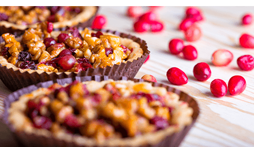 Small maple walnut cranberry pies in individual baking dishes