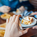 Person taking a picture of their meal with a smartphone
