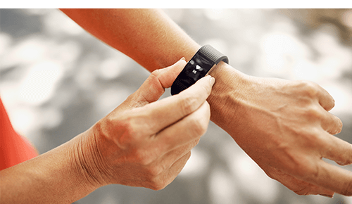 Person checking heart rate of wearable fitness device