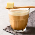 Cup of bulletproof coffee with a spoonful of butter resting on top