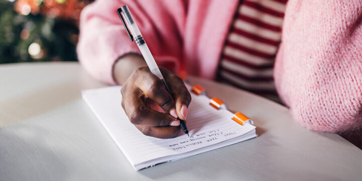 Close up of woman making a goal list
