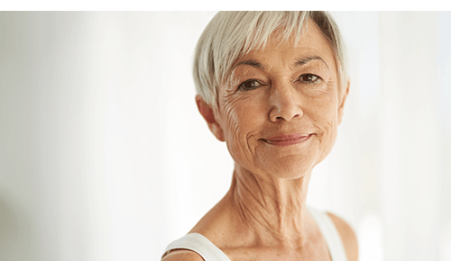 Older woman smiling and looking at camera Older woman smiling and looking at camera