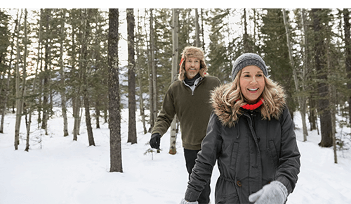 Couple hiking in the snow in a forest