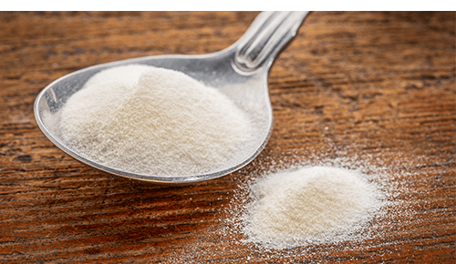 Spoon full of collagen supplement powder Spoon full of collagen supplement powder