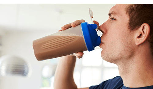Man drinking protein shake from bottle Man drinking protein shake from bottle