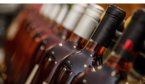 Closeup of row of wine bottles