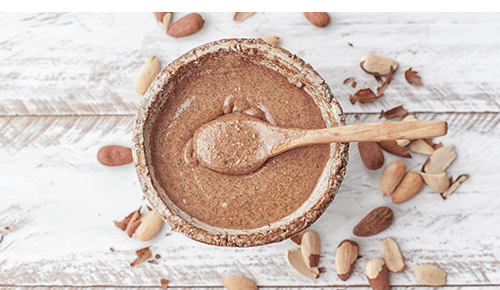Bowl of nut butter with spoon in it