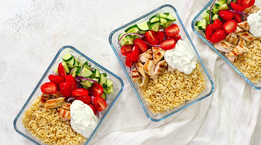 Three containers with meals planned for the week Three containers with meals planned for the week