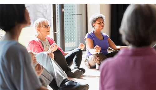 Group practicing yoga and meditation in a studio Group practicing yoga and meditation in a studio