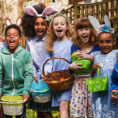 Group of children with Easter clothing on holding Easter baskets