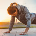 Person doing a push-up exercise outdoors