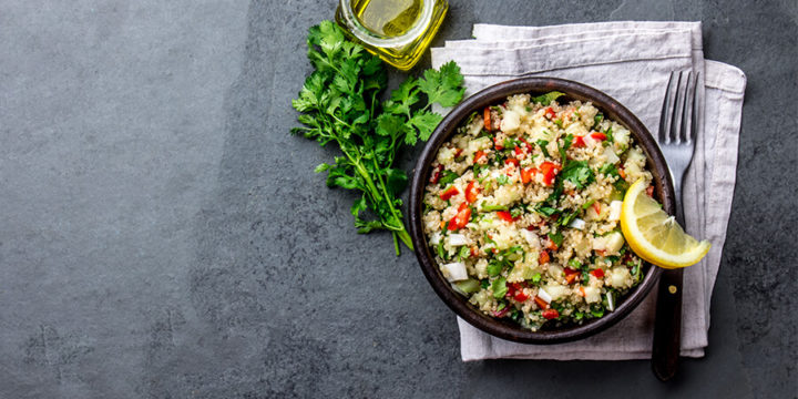Bowl of quinoa mixed with corn and zucchini