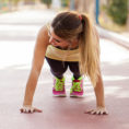 Two people doing push-ups outside