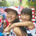 Mother and daughter wearing red, white and blue at a July Fourth celebration parade