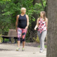 Two women wearing workout clothes while walking on outdoor path