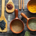 Variety of spoons and containers with different spices in them