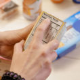 Closeup of person reading the nutritional label on a food container box