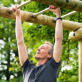Man exercising on bars in outdoor workout area