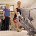Woman exercising while vacuuming with guidance from an exercise physiologist
