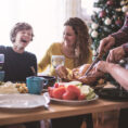 Family laughing and eating a meal together