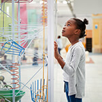 Child looking at installation in science museum