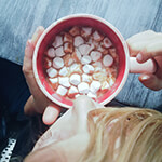 Person holding a mug full of hot chocolate and marshmallows