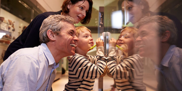 Parents and child looking at installation in museum