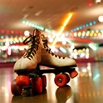 Closeup of roller skates sitting on the floor of a roller rink