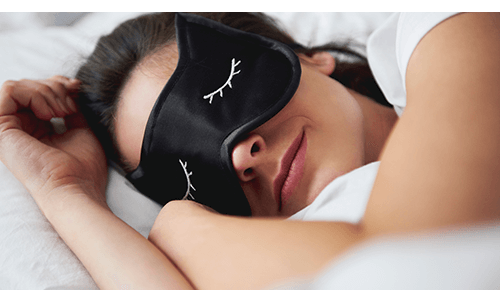 Person asleep with sleeping mask on