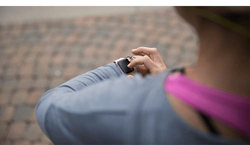 Person looking at fitness tracker on wrist