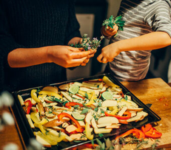 Parent and child cooking vegetables together