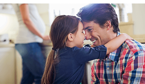 Father and child hugging and smiling at each other Father and child hugging and smiling at each other
