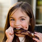 Child eating barbecue ribs