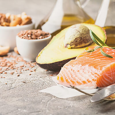 Closeup of foods with omega 3 and omega 6 like avocado and salmon