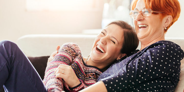 Adult child hugging smiling mother
