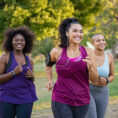 Group of three people running outside