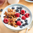 Bowl of yogurt with granola and berries on top