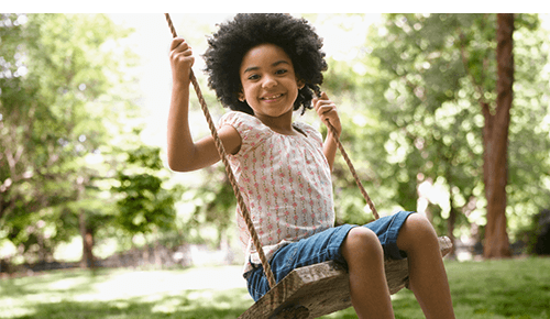 Child swinging at playground