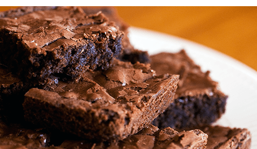 Plate piled with pieces of chocolate brownies