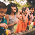 Group of children playing with bubbles outside