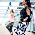Two people jump roping for exercise in urban setting