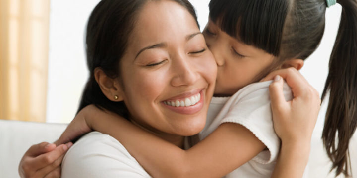 Child kissing mother on cheek